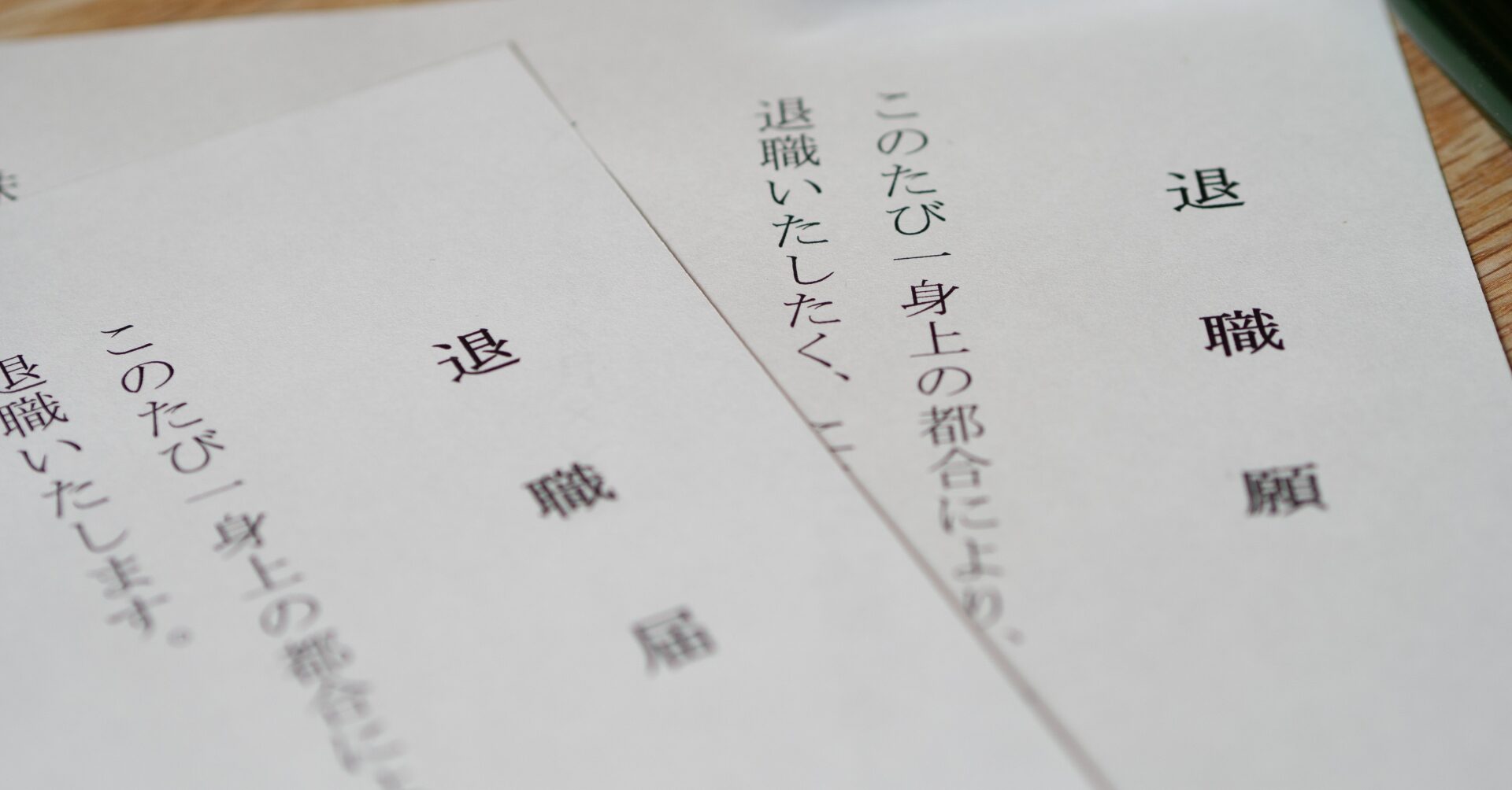 机の上に、印字された退職届の用紙と朱肉、印鑑が並べられている様子